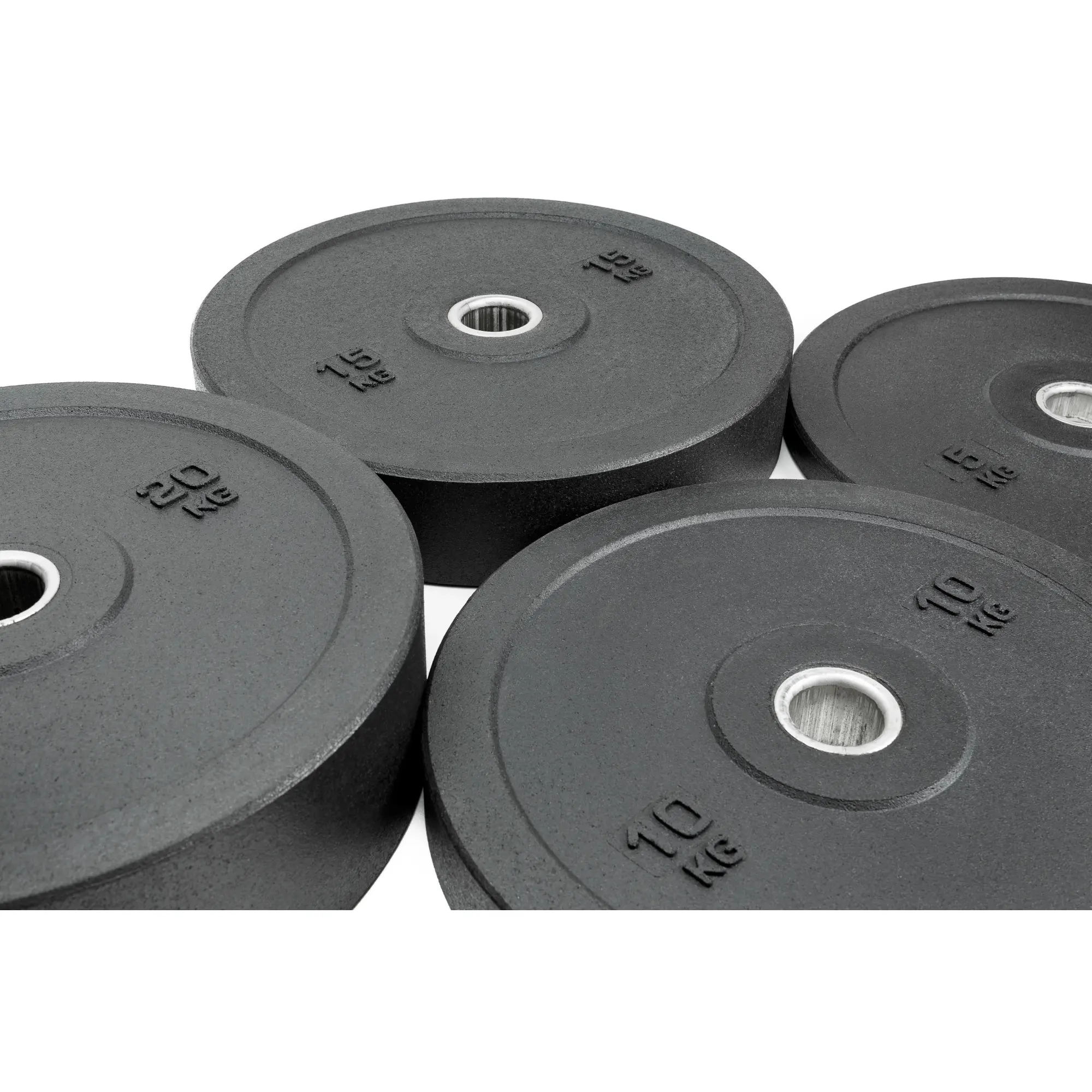 Obciążenia olimpijskie Bumper Essential położone obok siebie na podłodze